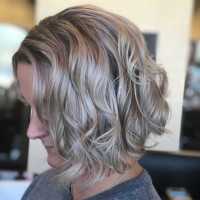 Woman with short blonde curly hair