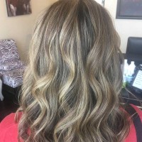 A woman with wavy, dirty-blonde hair