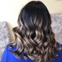 Brunette woman with curled gradient blonde hair