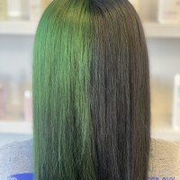 A woman with green and black hair