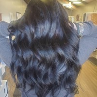 A woman with wavy, black hair.