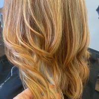 A woman with medium length red and blonde hair