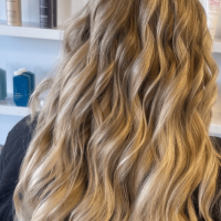 A woman with long, wavy, dirty-blonde hair