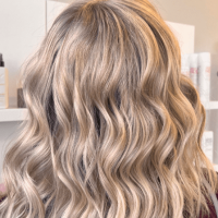 A woman with medium-length, platinum blonde hair