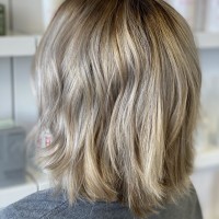 A woman with medium length, dirty-blonde hair